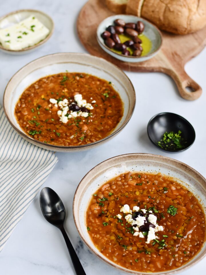 Greek-Lentil-Soup-with-Feta in 2 bowls with Greek olives